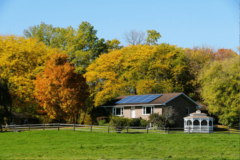 A house in front of trees with changing leaves in New York